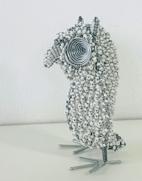 african beaded owl side view